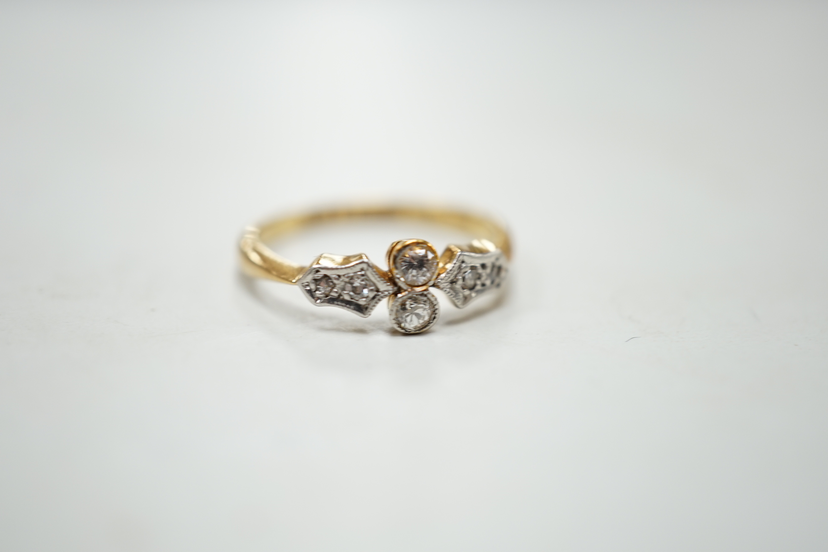 A 1920's 18ct, plat and six stone diamond chip set cluster ring, size M, gross weight 2.5 grams.
